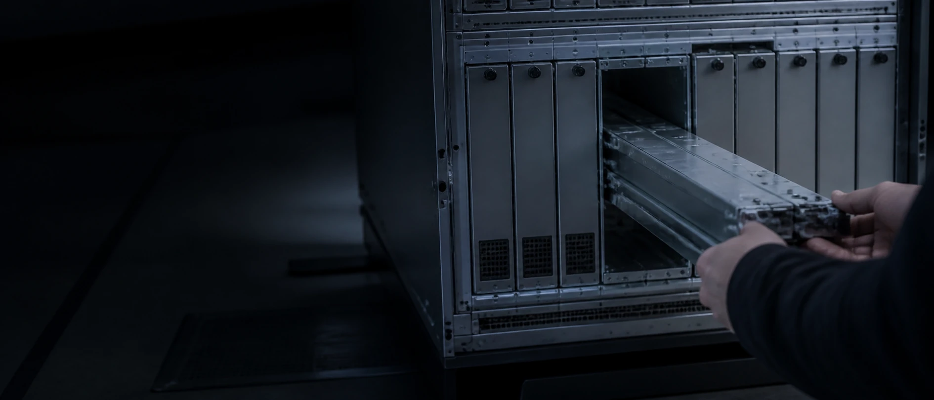 A technician swapping an interchangeable model module into a server rack.